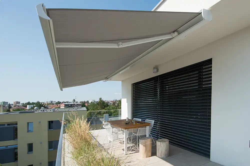 Markýza na balkonu se stolem a sezením